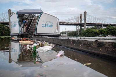 A solar-powered barge that filters plastic out of water, designed by Dutch NGO The Ocean Cleanup, deployed in the Rio Ozama, Dominican Republic, in 2020.