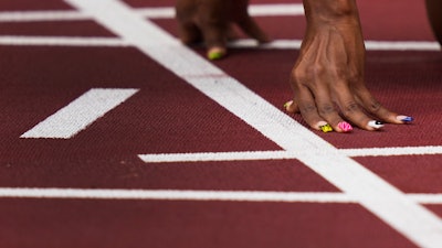 U.S. sprinter Javianne Oliver prepares to start in her heat of the women's 100-meters at the 2020 Summer Olympics, July 30, 2021, Tokyo.