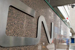 In this May 13, 2021, file photo, a man walks into Central Station next to Canadian National headquarters in Montreal. Kansas City Southern railroad is trying to keep its $33.6 billion merger with Canadian National on track by rejecting a competing $31 billion bid from rival Canadian Pacific earlier this week. Kansas City Southern said Thursday, Aug. 12, 2021, that its board unanimously decided to continue backing Canadian National's higher offer.