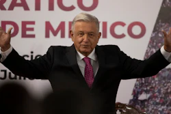 In this July 1, 2021 file photo, Mexican President Andres Manuel Lopez Obrador waves after giving a speech at a ceremony marking the third anniversary of his presidential election at the National Palace in Mexico City. Mexico's anti-monopoly regulator has on Wednesday, July 28, 2021, openly criticized President Lopez Obrador's plan to set a maximum price for cooking and heating gas.