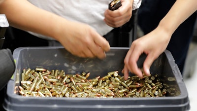 In this July 16, 2019, file photo, officers taking part in training load gun clips with ammunition at the Washington State Criminal Justice Training Commission in Burien, Wash. The COVID-19 pandemic coupled with record sales of firearms have created a shortage of ammunition in the United States that has impacting competition and recreational shooters, hunters, people seeking personal protection and law enforcement agencies.