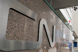 In this May 13, 2021, file photo, a man walks into Central Station next to Canadian National headquarters in Montreal. Kansas City Southern railroad is trying to keep its $33.6 billion merger with Canadian National on track by rejecting a competing $31 billion bid from rival Canadian Pacific earlier this week.