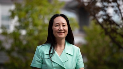 Meng Wanzhou, chief financial officer of Huawei, smiles as she leaves home to attend her extradition hearing at B.C. Supreme Court, in Vancouver, British Columbia, Monday, Aug. 9, 2021.
