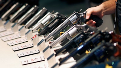 In this Jan. 19, 2016, file photo, handguns are displayed at the Smith & Wesson booth at the Shooting, Hunting and Outdoor Trade Show in Las Vegas. The Mexican government sued U.S. gun manufacturers and distributors, including some of the biggest names in guns like Smith & Wesson Brands, on Aug. 4, 2021 in U.S. federal court in Boston, arguing that their commercial practices have unleashed tremendous bloodshed in Mexico.
