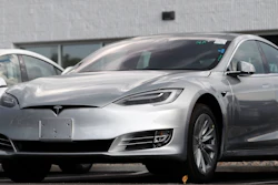 This July 8, 2018, file photo shows Tesla 2018 Model 3 sedans sitting on display outside a Tesla showroom in Littleton, Colo. The U.S. government has opened a formal investigation into Tesla's Autopilot partially automated driving system, saying it has trouble spotting parked emergency vehicles.
