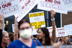 People in favor of and against a mask mandate for Cobb County schools gather and protest ahead of the school board meeting Thursday, Aug. 19, 2021, in Marietta, Ga.
