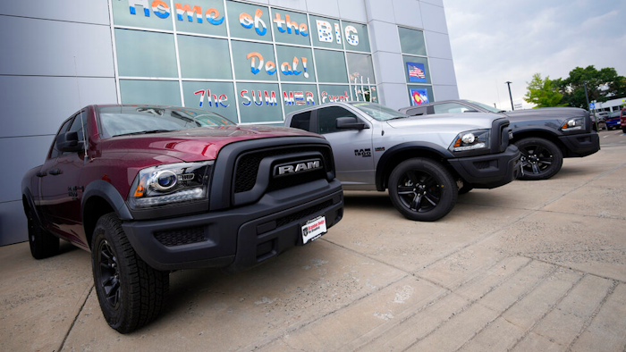 Unsold 2021 Ram pickup trucks parked on the storage lot outside a Ram dealership, Littleton, Colo., Aug. 29, 2021.