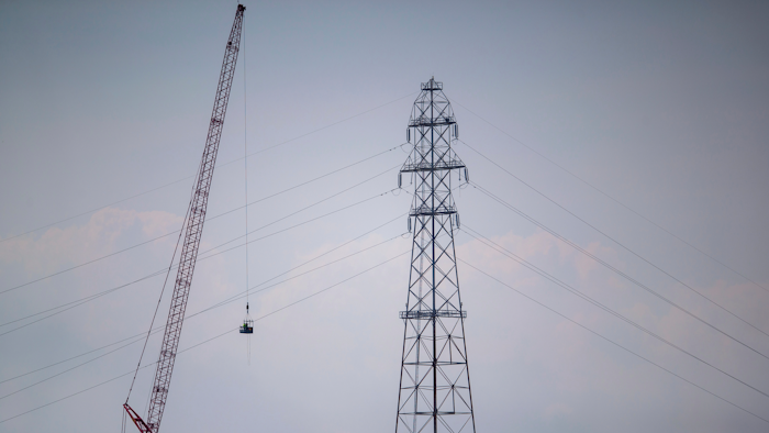 In this Friday, Sept. 3, 2021, file photo, Entergy contractors prepare to detonate transmission lines that fell into the Mississippi River Harahan, in New Orleans, after a tower collapsed during Hurricane Ida.