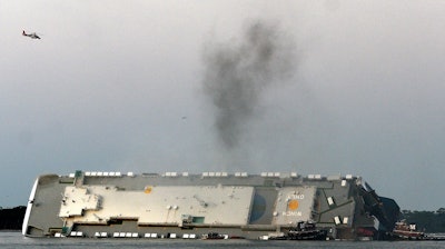 Smoke rises from a cargo ship capsized in the St. Simons Island, Georgia, sound, Sept. 8, 2019.