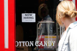 A 'NOW HIRING' sign is posted in the window of The Wharf Chocolate Factory at Fisherman's Wharf in Monterey, Calif. on Aug. 6.