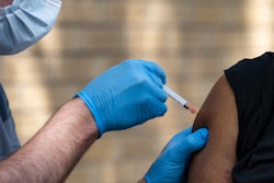 National Guard Spc. Noah Vulpi, left, administers the Johnson & Johnson COVID-19 vaccine to Ira Young Jr. during a vaccination clinic held by the National Guard in Odessa, Texas, May 27, 2021.