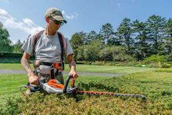 Tyler Campbell uses an electric hedge trimmer at the New York Botanical Garden, the Bronx, New York.