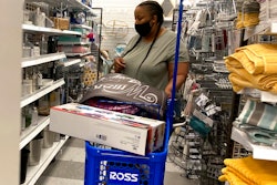 In this July 21, 2021 photo, a consumer shops as she wears a mask at a retail store in Morton Grove, Ill.
