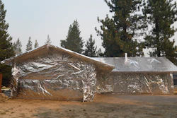Martin Diky's home completely wrapped in fire-resistant material to protect against the approaching Caldor Fire in Meyers, Calif., Sept. 1, 2021.