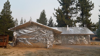 Martin Diky's home completely wrapped in fire-resistant material to protect against the approaching Caldor Fire in Meyers, Calif., Sept. 1, 2021.