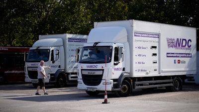 Instructor Graham Bolger directs learner truck driver Cadhene Lubin-Hewitt as he reverses at the National Driving Centre in Croydon, south London, Sept. 22, 2021.