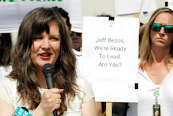 This May 22, 2019 file photo, Emily Cunningham, left, speaks as Kathryn Dellinger, right, looks on during a news conference following Amazon's annual shareholders meeting in Seattle. Amazon is settling with the two former tech workers who accused the company of illegally firing them last year for speaking out against the company. The former employees, Cunningham and Costa, publicly criticized the Seattle-based company and pushed Amazon to better protect warehouse workers from COVID-19.