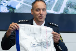 Police spokesman Thomas Geithner shows the remains of the metal foil of a balloon during a press conference in Dresden, Germany, Tuesday, Sept 14, 2021 discovered in the substation Dresden-Sued (Dresden-South).