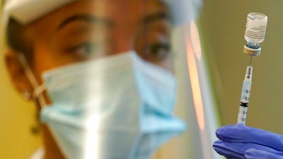 In this Jan. 8, 2021, file photo, a pharmacist prepares a syringe of the Pfizer vaccine for COVID-19, at Queen Anne Healthcare, a skilled nursing and rehabilitation facility in Seattle. The U.S. vaccination drive against COVID-19 stood on the verge of a major new phase as government advisers Thursday, Sept. 23, recommended booster doses of Pfizer's vaccine for millions of older or otherwise vulnerable Americans — despite doubts the extra shots will do much to slow the pandemic.