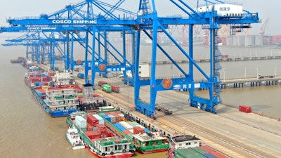 In this aerial photo, container ships are docked at a port on the Yangtze River in Nantong in eastern China's Jiangsu Province, Monday, Sept. 6, 2021. China's import and export growth accelerated in August despite disruptions due to the spread of the coronavirus's delta variant.