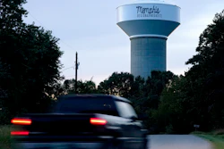 A truck drives down a rural road near a water tower marking the location of the Memphis Regional Megasite on Sept. 24, 2021, in Stanton, Tenn. Ford Motor Co. and SK Innovation of South Korea plan to build three new electric-vehicle battery factories and an auto assembly plant by 2025 in Tennessee and Kentucky. The industrial site in Stanton will be the location for a factory to produce electric F-Series pickups and a battery factory.