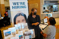 Marriott human resources recruiter Mariela Cuevas, left, talks to Lisbet Oliveros, during a job fair at Hard Rock Stadium, Friday, Sept. 3, 2021, in Miami Gardens, Fla.