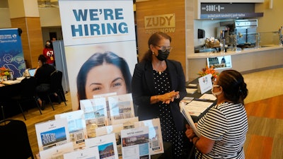 Marriott human resources recruiter Mariela Cuevas, left, talks to Lisbet Oliveros, during a job fair at Hard Rock Stadium, Friday, Sept. 3, 2021, in Miami Gardens, Fla.