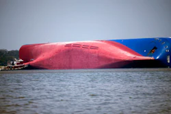 In this Sept. 9, 2019, file photo, a Moran tugboat nears the stern of the capsizing vessel Golden Ray near St. Simons Sound off the coast of Georgia.