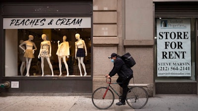 A retail location is for rent, Thursday, March 25, 2021, in the SoHo neighborhood of New York. The nation's business economists now expect slower economic growth this year due to the widespread delta variant of the coronavirus, while also saying the economy could improve more quickly next year as vaccinations become more accepted.