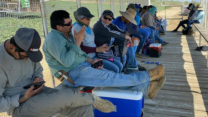 Farmworkers get a shade break while picking melons on a hot day in California.