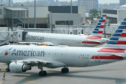 American Airlines jets prepare for departure near a terminal at Boston Logan International Airport, July 21, 2021.