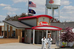 In this May 7, 2020 photo, workers leave the Tyson Foods pork processing plant in Logansport, Ind.