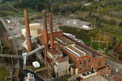 Smokestacks from the Greenidge Generation power plant tower above nearby homes, Friday, Oct. 15, 2021, in Dresden, N.Y.