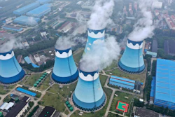 In this Sept. 27, 2021 file photo, steam billows out of the cooling towers at a coal-fired power station in Nanjing in east China's Jiangsu province. The world's facing an energy crunch.