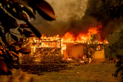 In this Sept. 23, 2021, file photo, flames consume a house near Old Oregon Trail as the Fawn Fire burns north of Redding in Shasta County, Calif. U.S. officials have approved a long-lasting fire retardant that could significantly aid in fighting increasingly destructive wildfires.