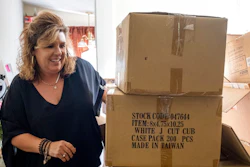 Ginger Pigg moves boxes of shopping bags in the storage room of her gift boutique The Perfect Pigg in Cumming, Ga. on Thursday afternoon, Oct. 22, 2021. The bags should have been delivered in four weeks, but took 14 weeks.