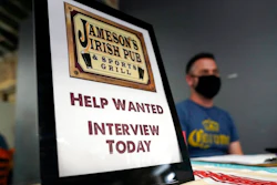 In this Sept. 22, 2021, file photo, a hiring sign is placed at a booth for Jameson's Irish Pub during a job fair in the West Hollywood section of Los Angeles. California's historic hiring slowed down in September as the state added 47,400 new jobs. California has been averaging more than 100,000 new jobs each month since February. New data released Friday, Oct. 22, 2021, by the U.S. Bureau of Labor Statistics shows California is now tied with Nevada for the highest unemployment rate in the country at 7.5%.