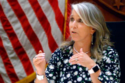 In this July 29, 2021, file photo New Mexico Gov. Michelle Lujan Grisham speaks at a news conference in Santa Fe, N.M. Grisham is returning to the podium next week at an annual gathering of oil executives. She's also contemplating attendance at the U.N. Climate Conference in Scotland in November, internal emails show.