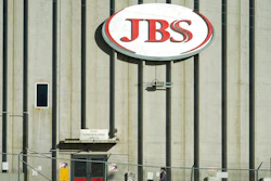 In this Oct. 12, 2020 file photo, a worker heads into the JBS meatpacking plant in Greeley, Colo. Meatpacker JBS Foods Inc. faces about $59,000 in fines after a worker fell into vat of chemicals used to process animal hides and died at one of the company's meat processing facilities in northern Colorado, officials said.