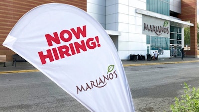A sign in the parking lot of Mariano's grocery store advertises the availability of jobs Friday, Oct. 8, 2021, in Chicago. One reason America’s employers are having trouble filling jobs was starkly illustrated in a report Tuesday, Oct. 12: Americans are quitting in droves.