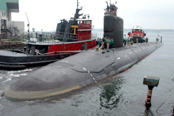 In this Friday, July 30, 2004 file photo, the U.S.S. Virginia returns to the Electric Boat Shipyard in Groton Conn., after its first sea trials. A Navy nuclear engineer with access to military secrets has been charged with trying to pass information about the design of American nuclear-powered submarines to someone he thought was a representative of a foreign government but who turned out to be an undercover FBI agent, the Justice Department said Sunday, Oct. 10, 2021.