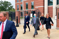 Former SCANA CEO Kevin Marsh, center, walks out of a courtroom with his lawyers after being sentenced to two years in prison for lying and deceiving the public about the progress of a pair of nuclear reactors in South Carolina that were never finished and wasted billions of dollars on Thursday, Oct. 7, in Columbia, S.C. Marsh also has pleaded guilty in state charges in the case.