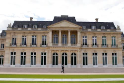In this June 7, 2017 file photo, the Organisation for Economic Co-operation and Development (OECD) headquarters is pictured in Paris, France. Nearly 140 countries have agreed on a tentative deal that would make sweeping changes to how big, multinational companies are taxed in order to deter them from stashing their profits in offshore tax havens where they pay little or no tax. The agreement announced Friday foresees countries enacting a global minimum corporate tax of 15% on the biggest, internationally active companies.