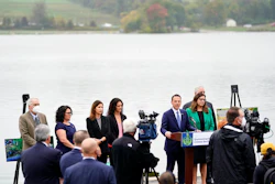 Pennsylvania Attorney General Josh Shapiro, at podium, speaks during a news conference at Marsh Creek State Park in Downingtown, Pa., Tuesday, Oct. 5, 2021. Shapiro filed criminal charges Tuesday against the developer of a problem-plagued pipeline that takes natural gas liquids from the Marcellus Shale gas field to an export terminal near Philadelphia.