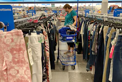 In this July 21,2021 photo, a consumer shops at a retail store in Morton Grove, Ill. U.S. consumer spending accelerated in August despite the surge in COVID cases, while the additional demand combined with supply shortages kept inflation high.