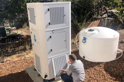 Ted Bowman, design engineer with Tsunami Products, installs a unit in homeowner Don Johnson's backyard in Benicia, Calif., Sept. 28, 2021. The recent invention can make water out of the air and in parched California, some homeowners are already buying the pricey devices. The air-to-water systems work like air conditioners by using coils to chill air, then collect water drops in a basin.