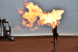 A flare burns natural gas at an oil well, Watford City, N.D., Aug. 26, 2021.