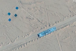This satellite image provided by Maxar Technologies shows a building on rail tracks in Ruoqiang county, China, Wednesday, Oct. 20, 2021. Satellite images appear to show China has built mock-ups of U.S. Navy aircraft carriers and destroyers in its northwestern desert.