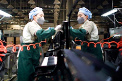 In this photo released by Xinhua News Agency, a worker cleans a piano at a production factory of Parsons Music Corporation in Yichang in central China's Hubei Province, Nov. 23, 2021. China's manufacturing activity rebounded in November as orders improved and power shortages eased, a survey showed Tuesday, Nov. 30, 2021.