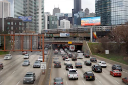In this March 31, 2021 file photo, traffic flows along Interstate 90 highway as a Metra suburban commuter train moves along an elevated track in Chicago. Congress has created a new requirement for automakers: find a high-tech way to keep drunken people from driving cars.